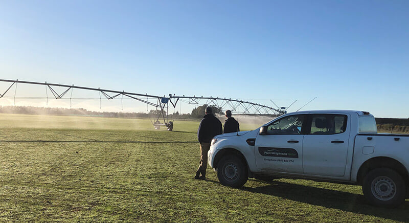 PGW Water rep with a customer looking at an irrigator